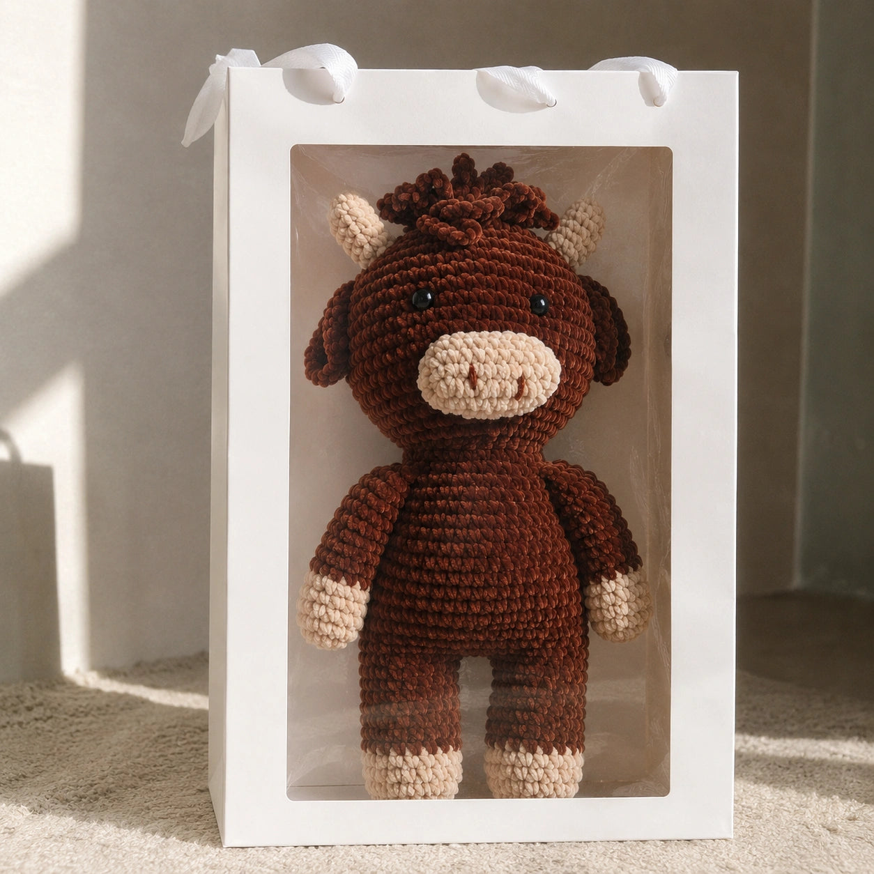 Handmade crochet Highland cow plush packaged as cozy handmade gift