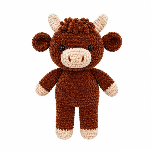 Handmade crochet Highland cow plush toy in soft brown velvet yarn on white background