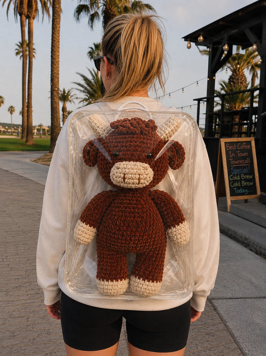 Large handmade crochet Highland cow plush shown outdoors for real size reference