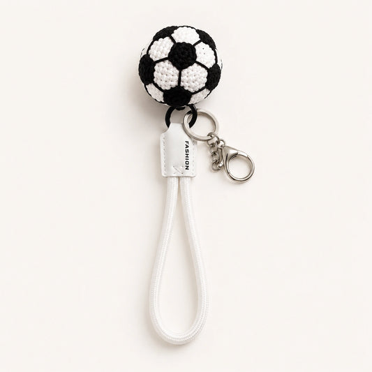 Handmade crochet soccer ball keychain with white nylon strap and metal clasp